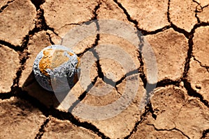 Water Crisis, Climate Change, El Nino, Global Warming Issue Concept. Brown Globe lay on Cracked Dry Soil Ground. Land without