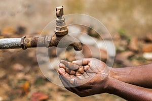 Water crisis is a serious threat to India and worldwide,a man holding his hand under the tap for water