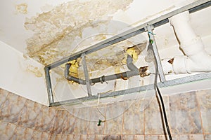 Water damage in condo bathroom ceiling, flooding from neighbor