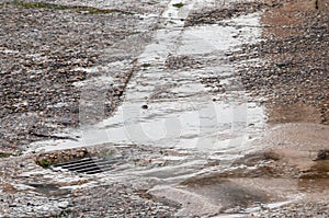Water damage to road from burst leaking water pipe