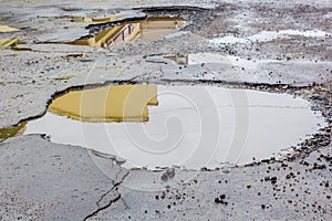 Water damaged by potholes in the road photo