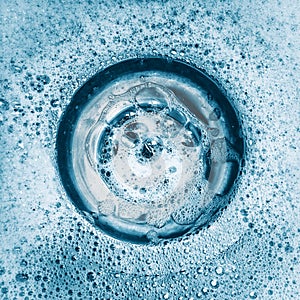 Acqua un detersivo in polvere comune giù il lavandino 