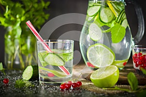 Water detox in a glass jar and a glass. Fresh green mint and berries. A refreshing and healthy drink.