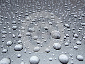 Water dew droplets on silver metallic paint background