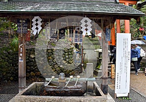 Water dippers in front of Fushimi Inari Shrine