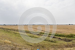 Water ditches irrigation system and a harvested grain field 