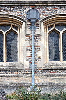 Water draining gutter downpipe on an old wall