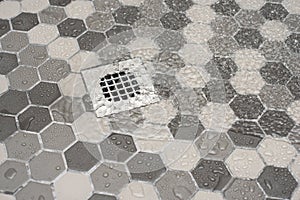 Water draining in tiled shower floor. photo