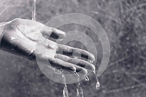 Water drains from the woman`s hand. Psychological problems concept. photo