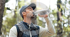 Water, drink and man with fitness hiking, exercise and thirsty in forest, nature and woods. Motivation, health and