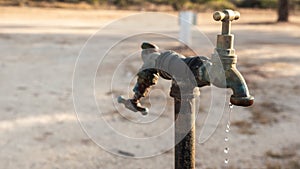 Water dripping from a double tap outdoors