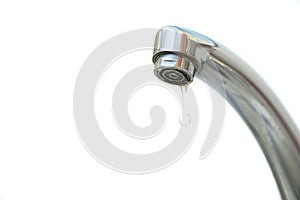 Water dripping from the tap and isolated white background