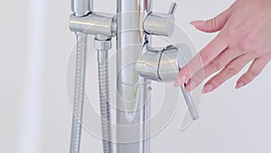 Water dripping to stop running as hand turn off the faucet. Save the water concept. Detect a Leak week. hand close water