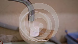 Water Drips into Sink from Old Water Tap in Bathroom. Water Leak. 4K