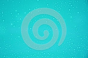Water drop on blue plastic background.