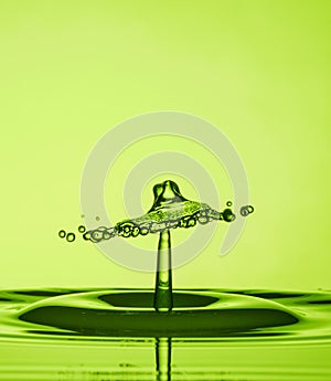 Water Drop Collisions Macro Photography with green  background