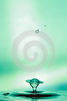 Water Drop Collisions Macro Photography with green background