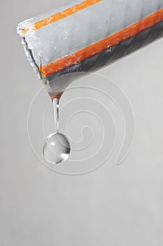 Water drop dripping out of a hose