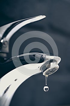 Water drop dripping from the tap