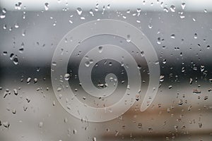 Water drop on glass mirror during raining in rainy day outside window glass
