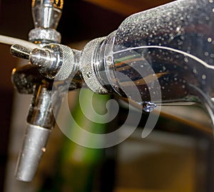 Water drop hanging on a beer tap