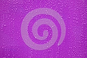 Water drop on purple background.