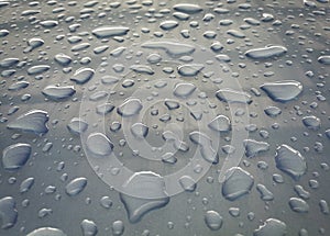 Water drop of rain on a blue car background