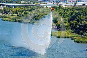 Water drop in river from helicopter bucket