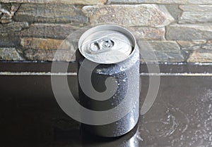 Water drop on tin can drink on black counter