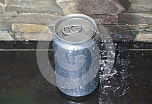 Water drop on tin can drink on black counter