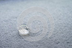 water drop on top of white fabric sheet