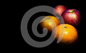 Water droplet on glossy surface of freshness orange and red apple