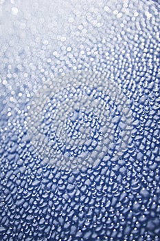 Water droplets on blue car background