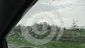Water droplets on the on car glass. Inside view of the car. Driving car during heavy rain