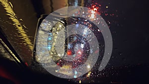 Water droplets on the car window in the evening. Vertical video for the smartphone.