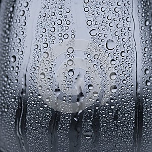 Water droplets cover a smooth glass surface creating a pattern