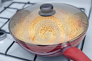 Water droplets formed under the lid of pan while cooking vegetable stew or soup. Cooking at home and recipes