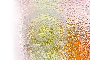 Water droplets on glass bottle of juice background.