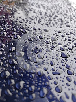 water droplets on a glass mirror metal like surface