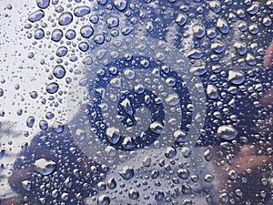 water droplets on a glass mirror metal like surface