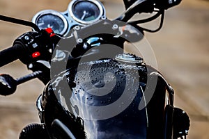 Water droplets on motorcycle fuel tank.