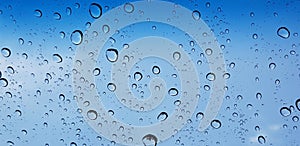 Water droplets perspective through window glass surface against blue sky good for multimedia content