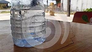 Water droplets beside the plastic bottle with cool temperature.