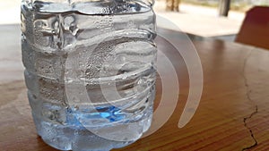 Water droplets beside the plastic bottle with cool temperature.