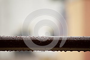 Water droplets from rain over the hand rail