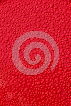 Water droplets on new red car background