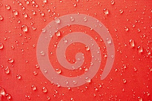 Water droplets on red color textile