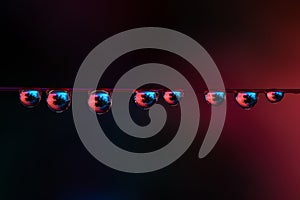 Water droplets on red wire