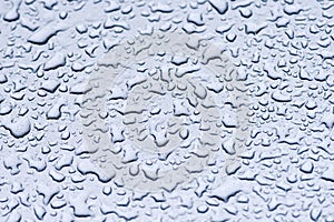 Water droplets on the turquoise surface of the metal