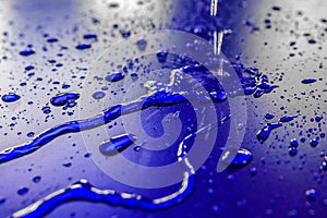 Water droplets on waterproof surface of the car vinyl film are blue purple